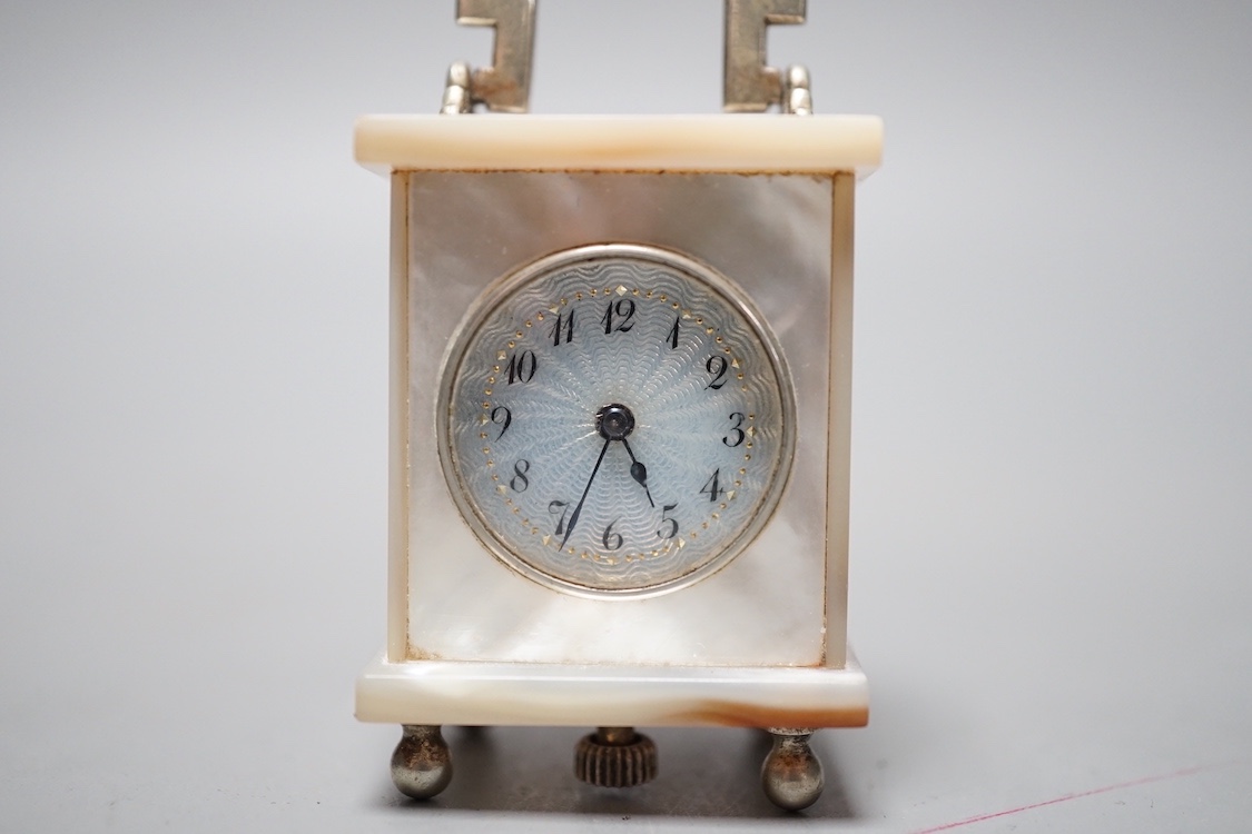 A miniature Swiss mother of pearl timepiece, engraved Brevet above a cross and numbered 33817, 4 cms high.